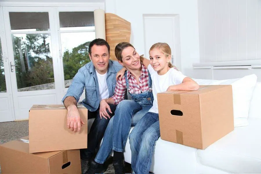 family sitting near boxs