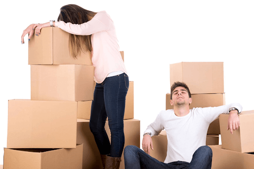 Couple sitting next to boxes